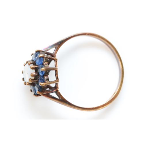 390 - A 9ct gold vintage opal and sapphire cluster ring, claw set, London 1972, N, 2.3g