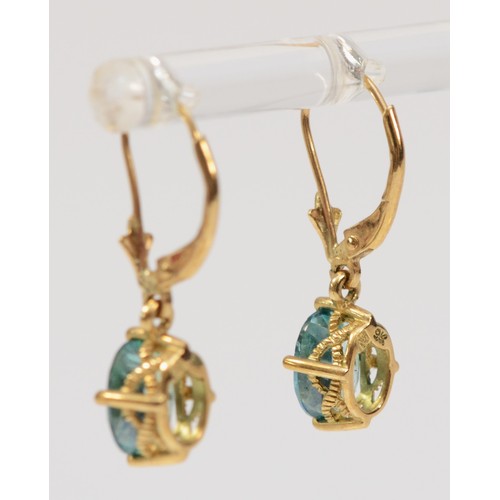 403 - A pair of 9ct gold oval cut blue gemstone drop earrings with lever backs, 8mm drop, 2.2g