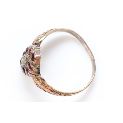 407 - A 9ct gold antique garnet and seed pearl dress ring with patterned shoulders, one setting vacant, P,... 