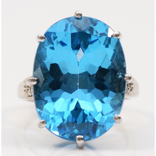 576 - A 9ct white gold oval cut blue topaz dress ring with diamond shoulders, 20mm x15mm topaz,  N 1/2, 9.... 