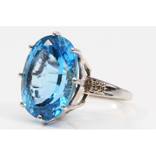 576 - A 9ct white gold oval cut blue topaz dress ring with diamond shoulders, 20mm x15mm topaz,  N 1/2, 9.... 