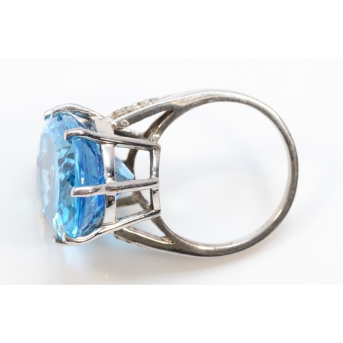 576 - A 9ct white gold oval cut blue topaz dress ring with diamond shoulders, 20mm x15mm topaz,  N 1/2, 9.... 