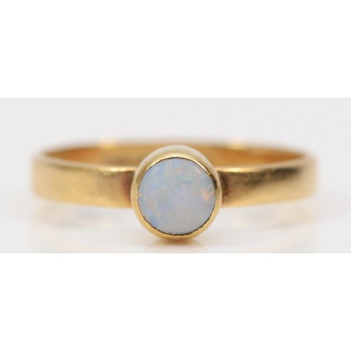 577 - A 9ct gold bezel set opal solitaire ring, E, 0.9g