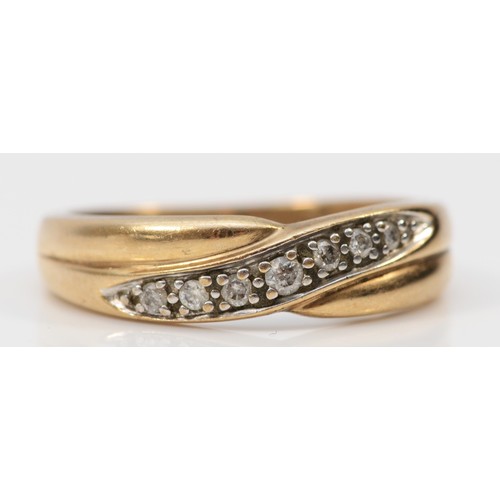 579 - A 9ct gold diamond crossover ring, N, 2.6g