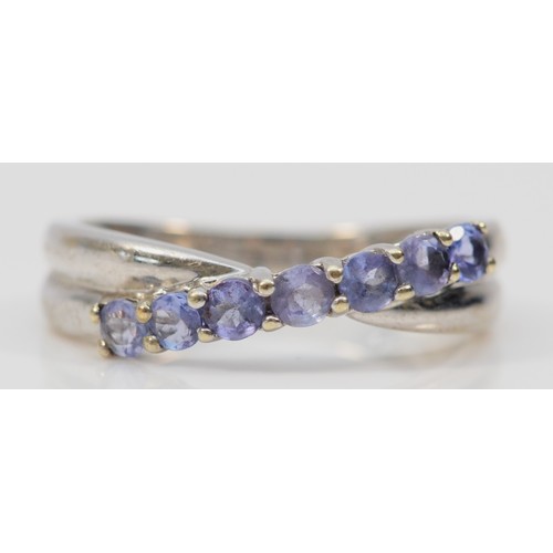 582 - A 9ct white gold tanzanite crossover ring, claw set, M, 2.5g