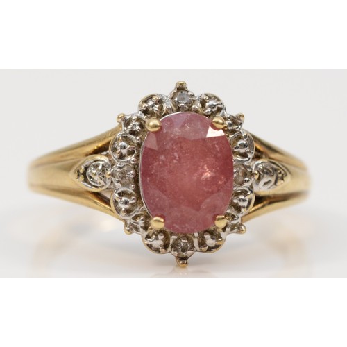 583 - A 9ct gold oval cut ruby and diamond cluster ring, R, 4g