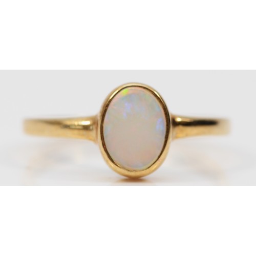 586 - A 9ct gold bezel set opal dress ring, P, 1.9g