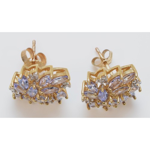 592 - A pair of 9ct gold marquise cut tanzanite and diamond stud earrings with scroll backs, 10mm, 3.4g