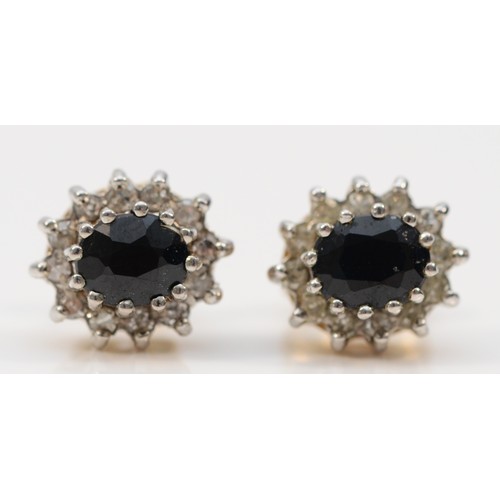 593 - A pair of 9ct gold sapphire and diamond cluster stud earrings with scroll backs, 6mm, 1.6g