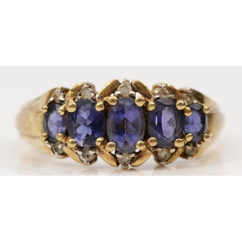 603 - A 9ct gold iolite five stone ring with diamond surround, S, 3.1g