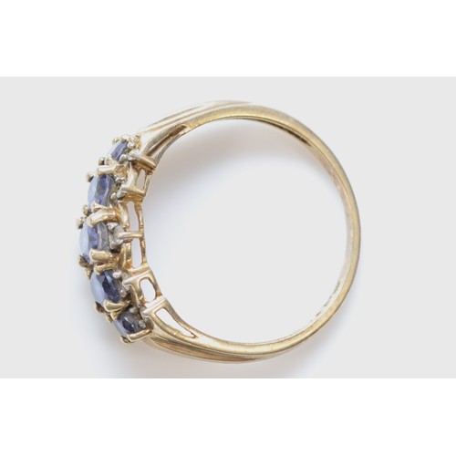 603 - A 9ct gold iolite five stone ring with diamond surround, S, 3.1g