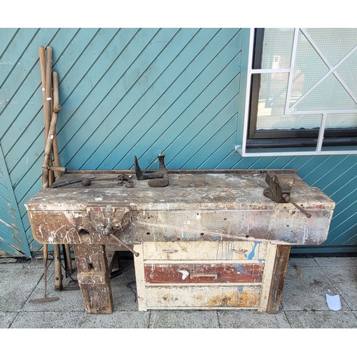 53 - A 20th century pitch pine workbench, having two attached vices, bank of three drawers below with a s... 