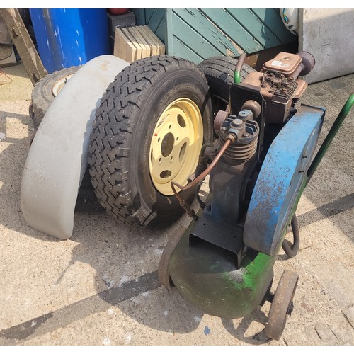 55 - A 20th century Briggs & Stratton petrol driven compressor, together with six vehicle wheels, a pair ... 