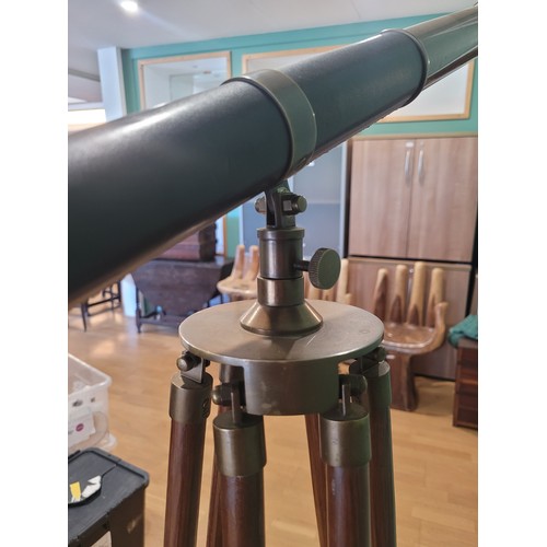 23 - A reproduction brass drawer telescope, replicating a 19th century example, mounted on a mahogany adj... 