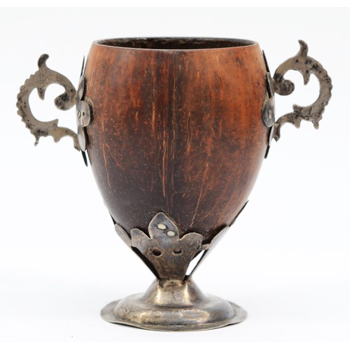 8 - An 18th century unmarked silver and coconut cup, with two handles, raised on a pedestal foot, 10cm