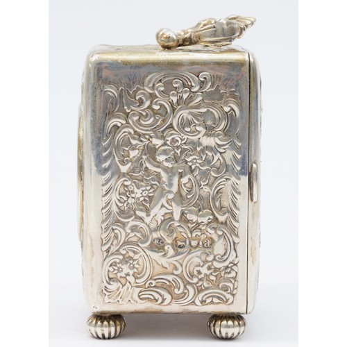 13 - A Victorian silver desk time piece, by William Comyns, London 1896, with embossed cherub and scroll ... 