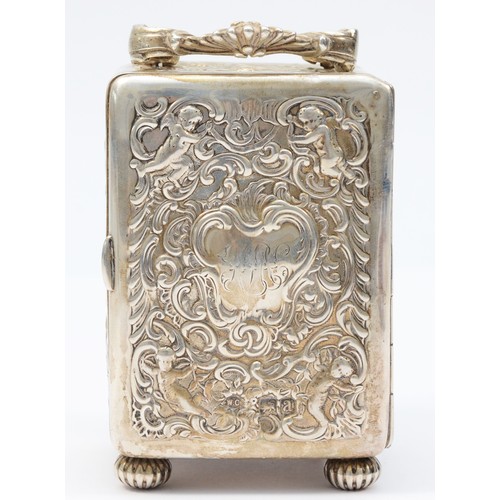 13 - A Victorian silver desk time piece, by William Comyns, London 1896, with embossed cherub and scroll ... 