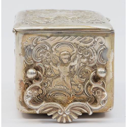 13 - A Victorian silver desk time piece, by William Comyns, London 1896, with embossed cherub and scroll ... 