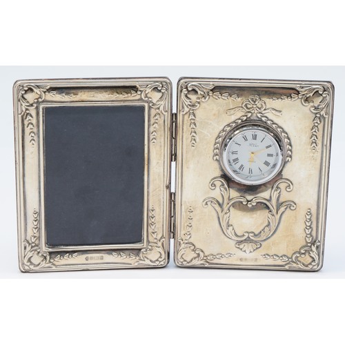 15 - A silver combination photograph frame and quartz clock, by Carr, Sheffield 1997, wooden back, 18 x11... 