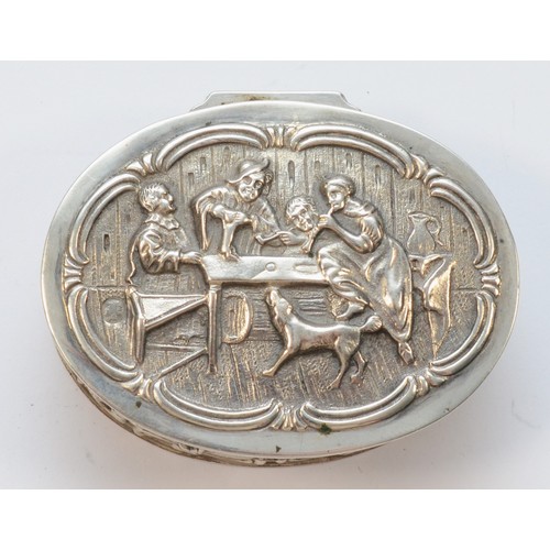 22 - A Dutch 800 standard silver oval box, bearing control marks, embossed with a tavern scene, 5.5 x 4.5... 