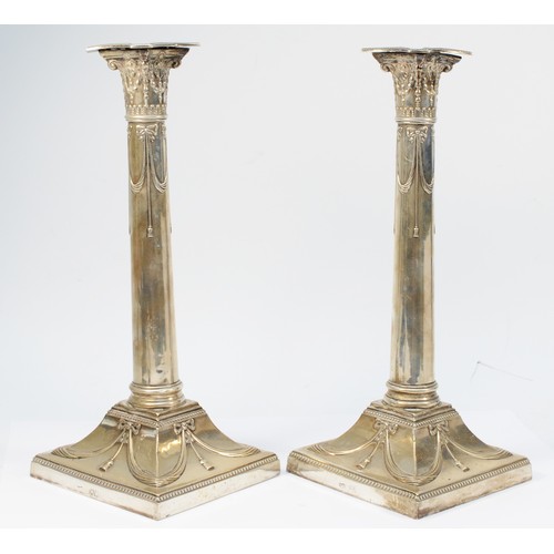 28 - An Edwardian silver pair of candlesticks, by the Goldsmiths & Silversmiths Co. Ltd., London 1905, wi... 