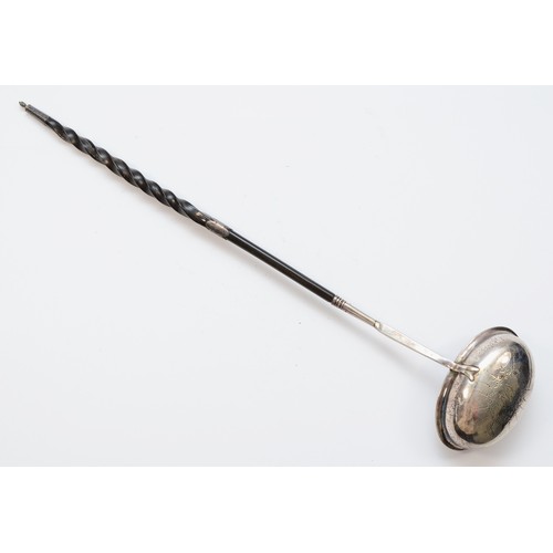 29 - A George III silver and whalebone ladle, London 1972, with bright cut engraved decoration, 38cm