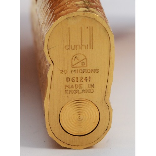 57 - Dunhill, a gold plated bark finish rollagas S lighter, serial number D61241, apparently unused, with... 