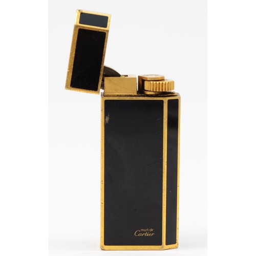 60 - Must de Cartier, a gold plated and black enamel rollagas lighter, serial number 53887X, 58mm