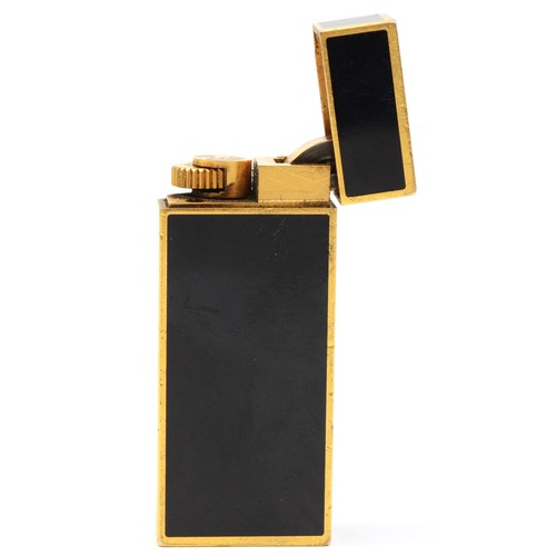 60 - Must de Cartier, a gold plated and black enamel rollagas lighter, serial number 53887X, 58mm