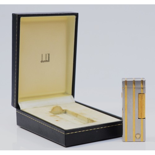 62 - Dunhill, a stainless steel and gold plated rollagas lighter, serial number 40028, case