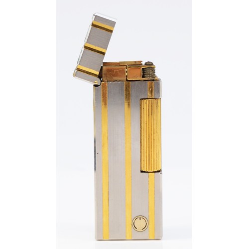 62 - Dunhill, a stainless steel and gold plated rollagas lighter, serial number 40028, case