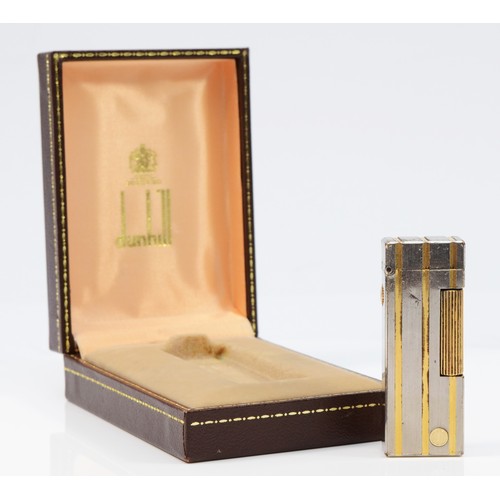 63 - Dunhill, a stainless steel and gold plated rollagas lighter, no serial number, case