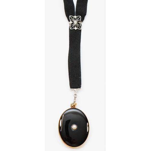 73 - An American late 19th century 14K gold, black enamel and pearl locket, opening to reveal two compart... 