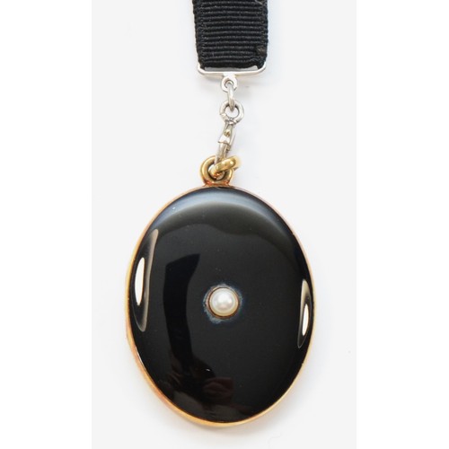 73 - An American late 19th century 14K gold, black enamel and pearl locket, opening to reveal two compart... 