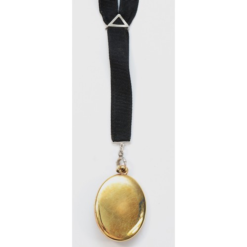 73 - An American late 19th century 14K gold, black enamel and pearl locket, opening to reveal two compart... 