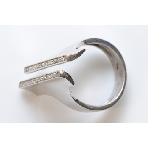 74 - A white gold diamond ring, two rows of single cut diamonds to a modernist style cuff ring, front mea... 