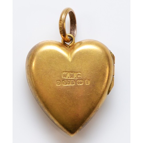 79 - An Edwardian 9ct gold heart shaped locket pendant, with pearl and red paste flower detail to the fro... 