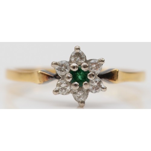 82 - An 18ct gold diamond and emerald floral cluster ring, a single emerald flanked by brilliant cut diam... 