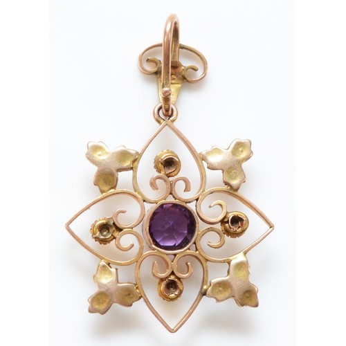 88 - A 9ct gold Edwardian amethyst and pearl pendant, in a floral design with one central amethyst, total... 