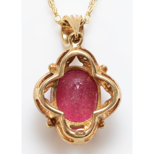 94 - A 9ct gold oval cut ruby and diamond pendant with chain, 10mm x 7mm ruby, 3.3g