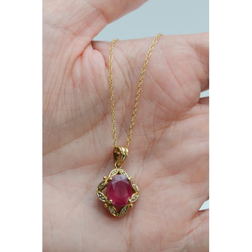 94 - A 9ct gold oval cut ruby and diamond pendant with chain, 10mm x 7mm ruby, 3.3g