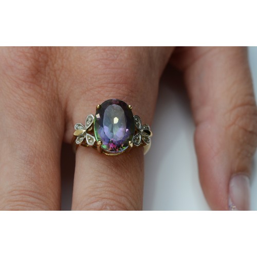 103 - A 9ct gold mystic topaz and diamond dress ring, butterfly shaped diamond shoulders, 13mm x 10mm topa... 