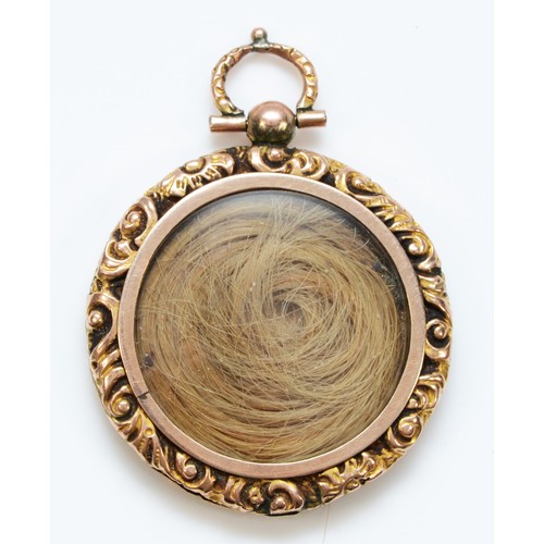 114 - A 9ct gold antique double sided locket pendant with repousse frame, 30mm diameter, photo to one side... 