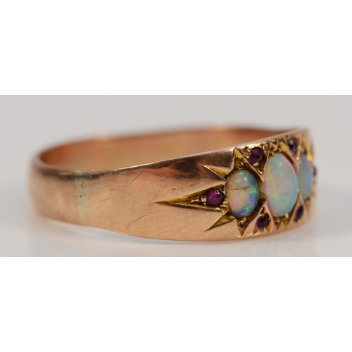 120 - A 9ct rose gold vintage opal and ruby dress ring, three opals with the largest being 5mm, R 1/2, 2.5... 