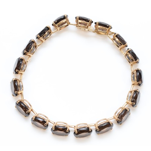 151 - A 9ct gold oval cut smokey quartz bracelet, 18cm, 15g