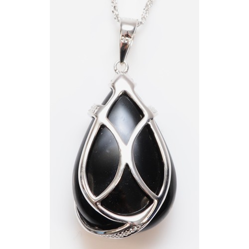 154 - A 9ct white gold black onyx and diamond pendant with chain, 25mm drop, 5.5g