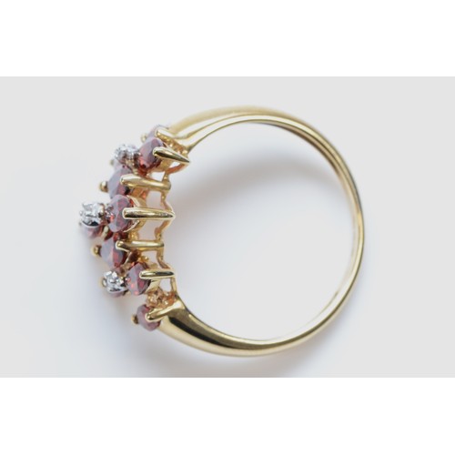 166 - A 9ct gold garnet and diamond dress ring, marquise cut garnets with three diamonds, T, 3.6g