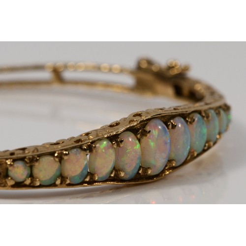 168 - A 9ct gold and graduated opal hinged bangle, Birmingham, c.1980, 58 x 51mm internal, 12gm