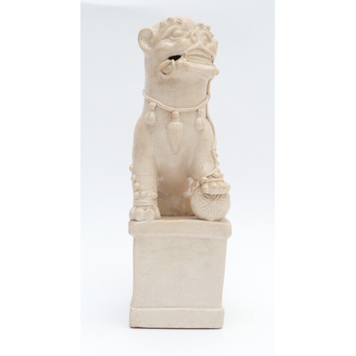 323 - A Chinese blanc de chine figure of a Dog of Fo, late 19th/early 20th century, modelled seated with i... 