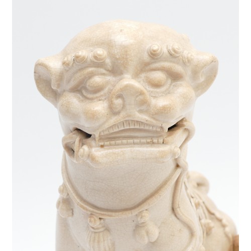 323 - A Chinese blanc de chine figure of a Dog of Fo, late 19th/early 20th century, modelled seated with i... 